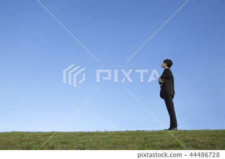 Side view full-length portrait of a businessman thinking diagonally upwards against a blue sky. Hope / Dream / Outlook / Free Image Side view full-length portrait of a businessman thinking diagonally upwards against a blue sky. Hope / Dream / Outlook / Free Image 44486728