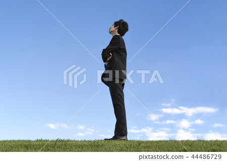 Side view full-length portrait of a businessman thinking diagonally upwards against a blue sky. Hope / Dream / Outlook / Free Image Side view full-length portrait of a businessman thinking diagonally upwards against a blue sky. Hope / Dream / Outlook / Free Image 44486729