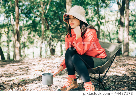 Woman cooking in the mountains Woman cooking in the mountains 44487178