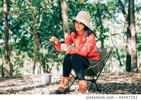 Woman sowing beans in a coffee mill Woman sowing beans in a coffee mill 44487281