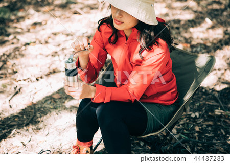 Woman sowing beans in a coffee mill 44487283