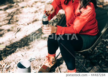 Woman sowing beans in a coffee mill 44487284