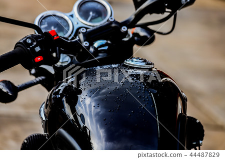 Water droplets on motorcycle fuel tank 44487829