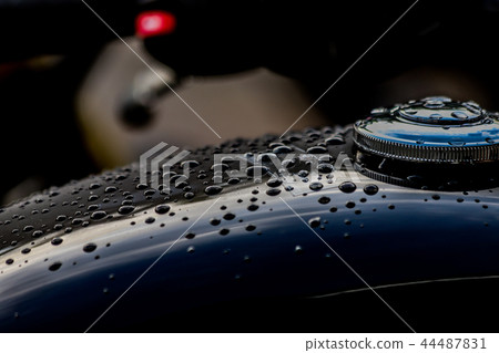 Water droplets on motorcycle fuel tank 44487831
