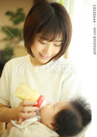 Mother giving milk 44488365