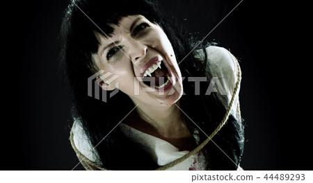 Crazy bloody scary zombie woman screams at camera Crazy bloody scary zombie woman screams at camera 44489293