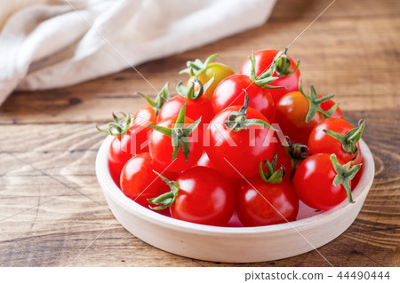 Cherry tomatoes red in ceramic bowl on wooden 44490444