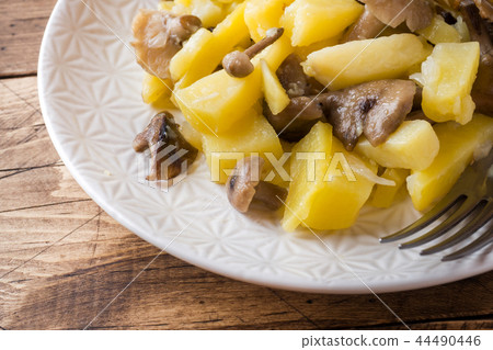 Fried potatoes with mushrooms and onions. Fried potatoes with mushrooms and onions. 44490446