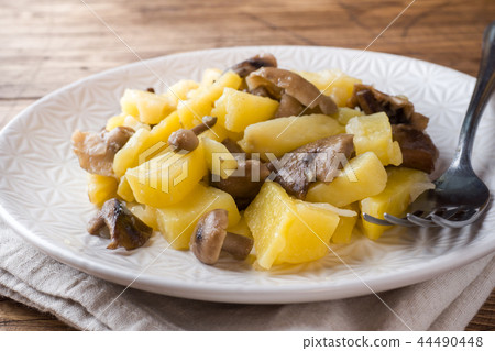 Fried potatoes with mushrooms and onions. Fried potatoes with mushrooms and onions. 44490448
