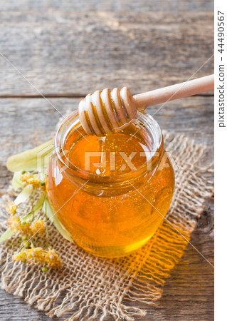 Glass jar of honey, Linden flowers Glass jar of honey, Linden flowers 44490567