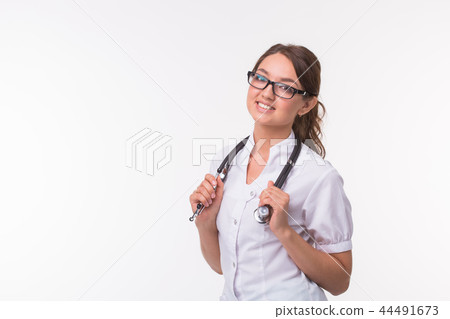 Medical concept of young beautiful female doctor in white coat with phonendoscope on white Medical concept of young beautiful female doctor in white coat with phonendoscope on white 44491673