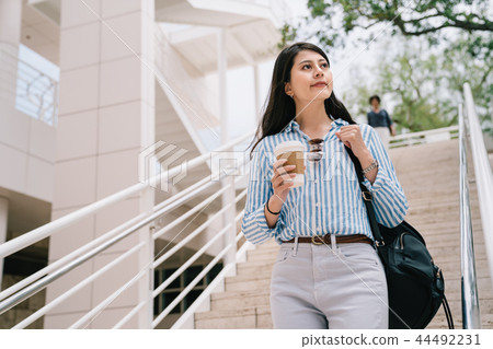 a pretty girl walking down the stairs a pretty girl walking down the stairs 44492231