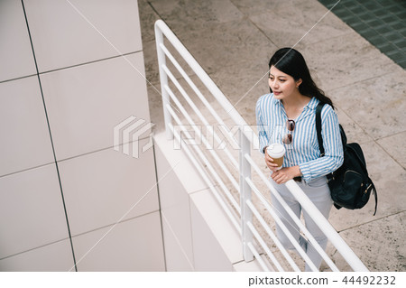 beautiful lady relying her hands on the handrail beautiful lady relying her hands on the handrail 44492232