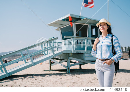 tourist standing next to lifeguard station 44492248