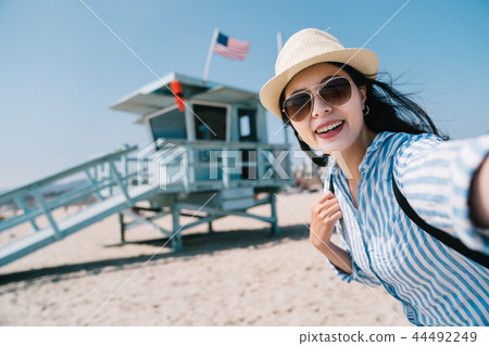 traveler taking selfie with the lifeguard station 44492249