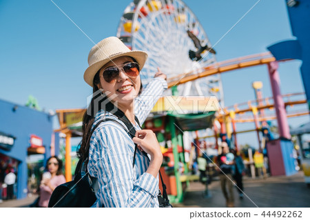 traveler pointing to the Ferris wheel traveler pointing to the Ferris wheel 44492262
