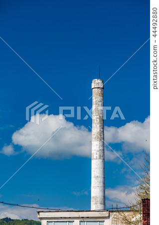 White chimney of abandoned Bulgarian factory 44492880