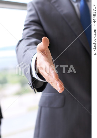 Unknown business man offering handshake while standing straight. Success cooperation and agreement Unknown business man offering handshake while standing straight. Success cooperation and agreement 44493717