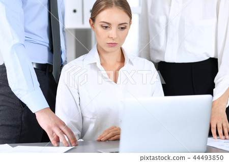 Group of business people using laptop computer in office. Meeting and teamwork concept Group of business people using laptop computer in office. Meeting and teamwork concept 44493850