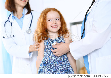 Doctor examining a little girl with stethoscope.Medicine and healthcare concept Doctor examining a little girl with stethoscope.Medicine and healthcare concept 44493977