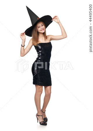 Full length playful Halloween witch on white background Full length playful Halloween witch on white background 44495400