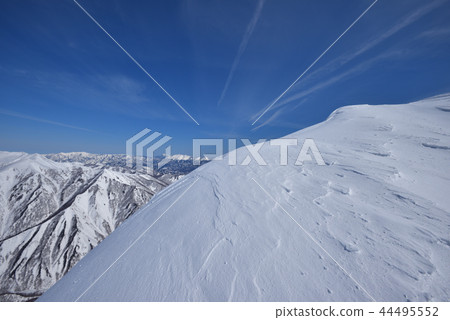 Snowy mountain and blue sky and contrail 44495552