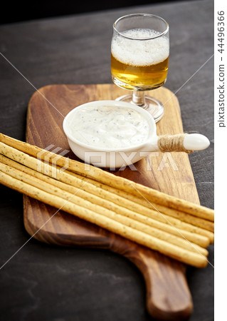 golden beer and delicious salty snacks on an old black wooden table golden beer and delicious salty snacks on an old black wooden table 44496366