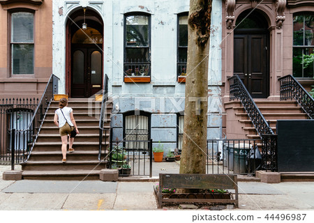 Woman at classic old apartment building in Greenwich Village 44496987