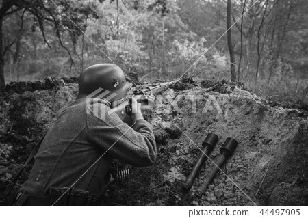 German Wehrmacht Infantry Soldier In World War II Hidden Sitting 44497905