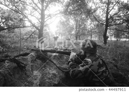 German Wehrmacht Infantry Soldier In World War II Hidden Sitting 44497911