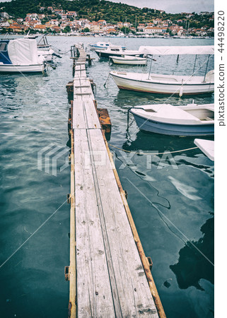 Wooden pier with boats in harbor, Trogir, Croatia 44498220