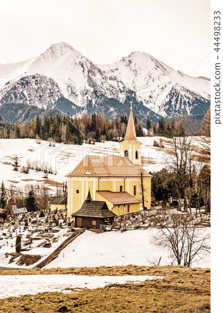 Church with cemetery in Zdiar with Belianske Tatry Church with cemetery in Zdiar with Belianske Tatry 44498233