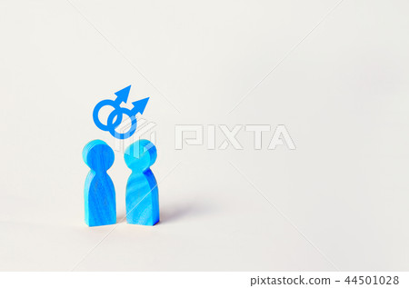 two blue wooden figures of people stand 44501028