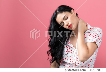 Young woman suffering from neck pain 44502813