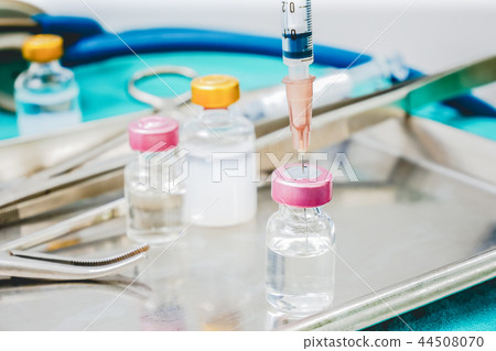 Syringe and medicine vials on doctor work park table close up for healthcare diagnosis concept 44508070