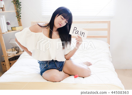 Beautiful young woman suffering from backache. Beautiful young woman suffering from backache. 44508363