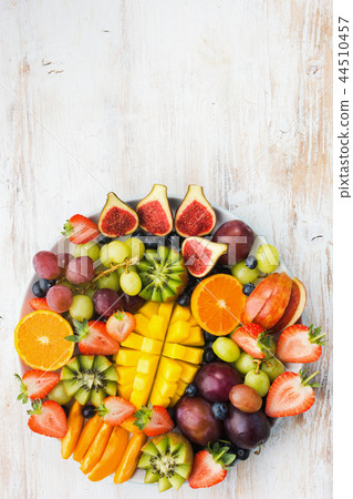 Rainbow fruits berries on white wood Rainbow fruits berries on white wood 44510457
