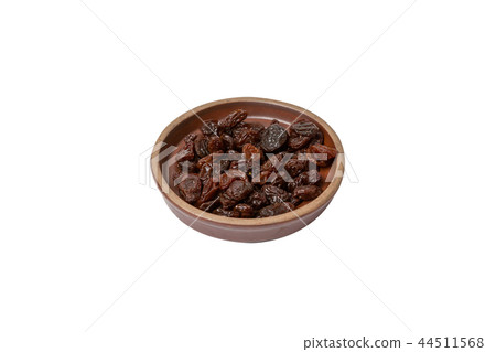 Pile of raisins in a plate on white background 44511568