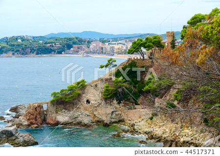 Beautiful view of rocky coast and castle by beach Beautiful view of rocky coast and castle by beach 44517371