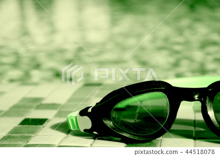 Glasses for diving on the edge of a summer pool Glasses for diving on the edge of a summer pool 44518078