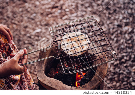 Roasting Khao Kriab or rice flour Thai local snack 44518334