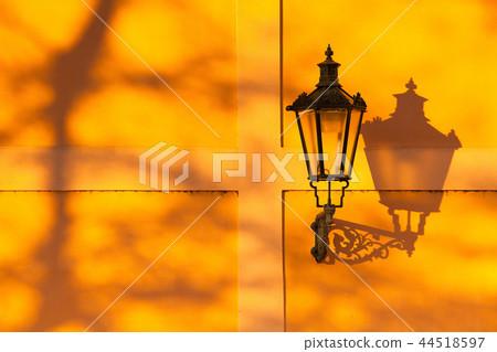 The retro street light on the wall at sunset. 44518597
