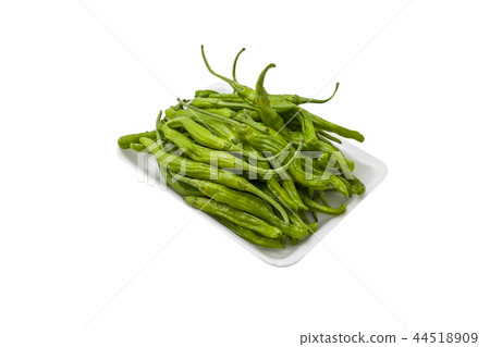 Pile of chilis in a container on white background Pile of chilis in a container on white background 44518909