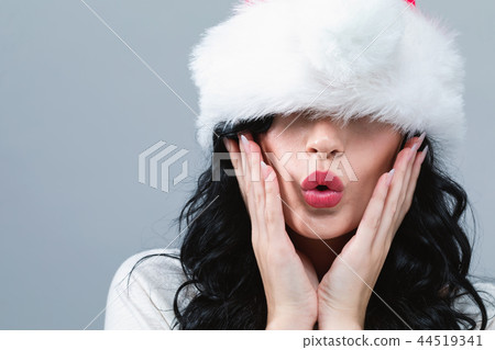 Woman with a Santa hat pulled over her eyes 44519341