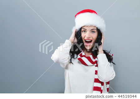 Happy woman with a Santa hat 44519344