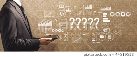 Question marks with businessman holding a tablet computer  44519538
