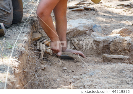 Archaeologist hands working with broom in antique fort 44519855