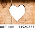 Heart carved in dark wooden wall texture, with bokeh background isolated 44520283