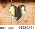 Heart carved in wooden wall texture, with bokeh background 44520284