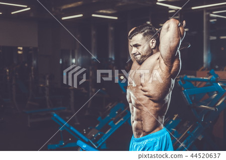 Handsome model muscle man abs workout in gym 44520637